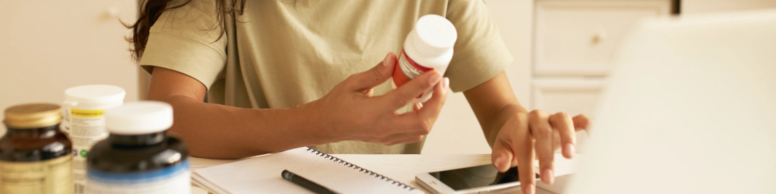 holding a container of medication